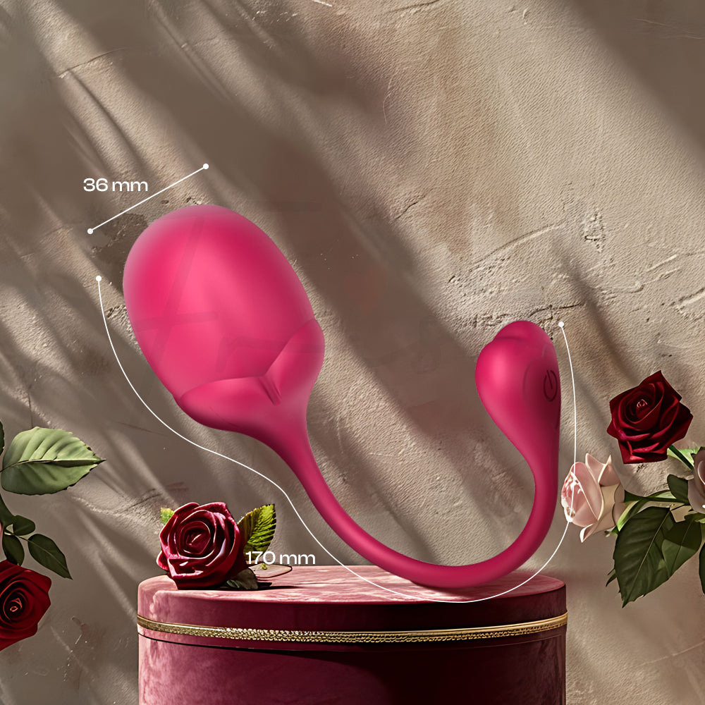 Pink Kegel egg resting on silky fabric with warm lighting for a sensual display