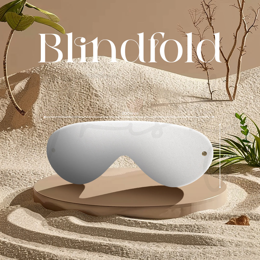 White padded blindfold shown on a textured surface with warm neutral lighting