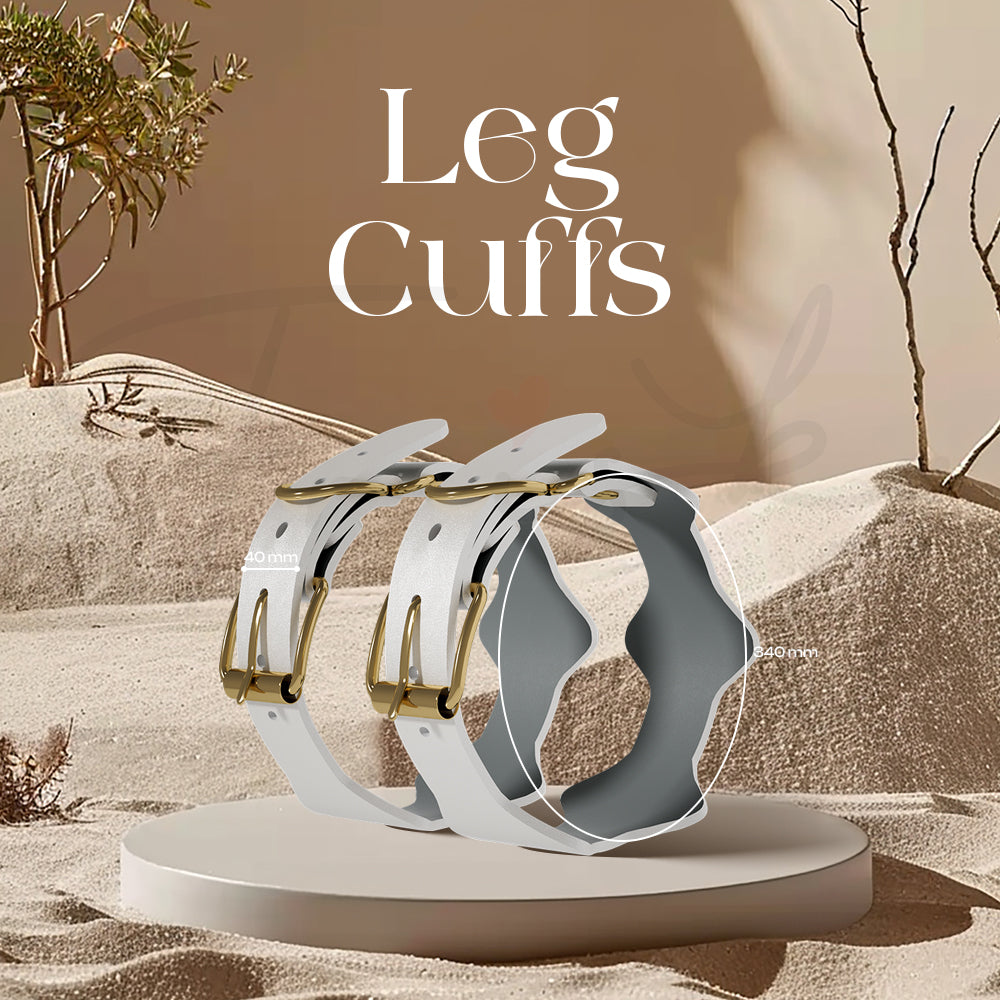 White and gold leg cuffs presented on a round platform against a warm backdrop