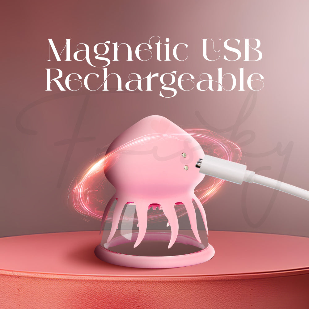 Pink jelly fish-shaped suction vibrator with a USB cable on a pink background, labeled 'Magnetic USB Rechargeable'.