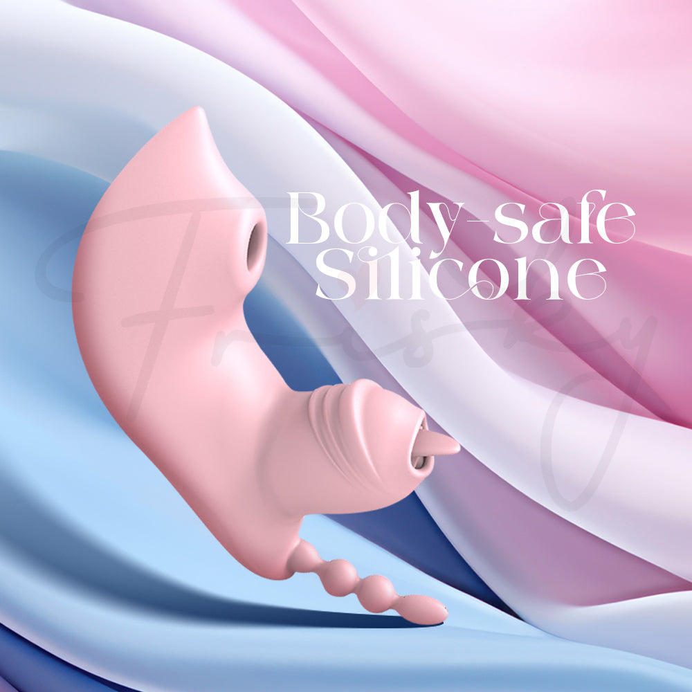Close-up of pink vibrator resting on blue fabric showing soft body-safe silicone.