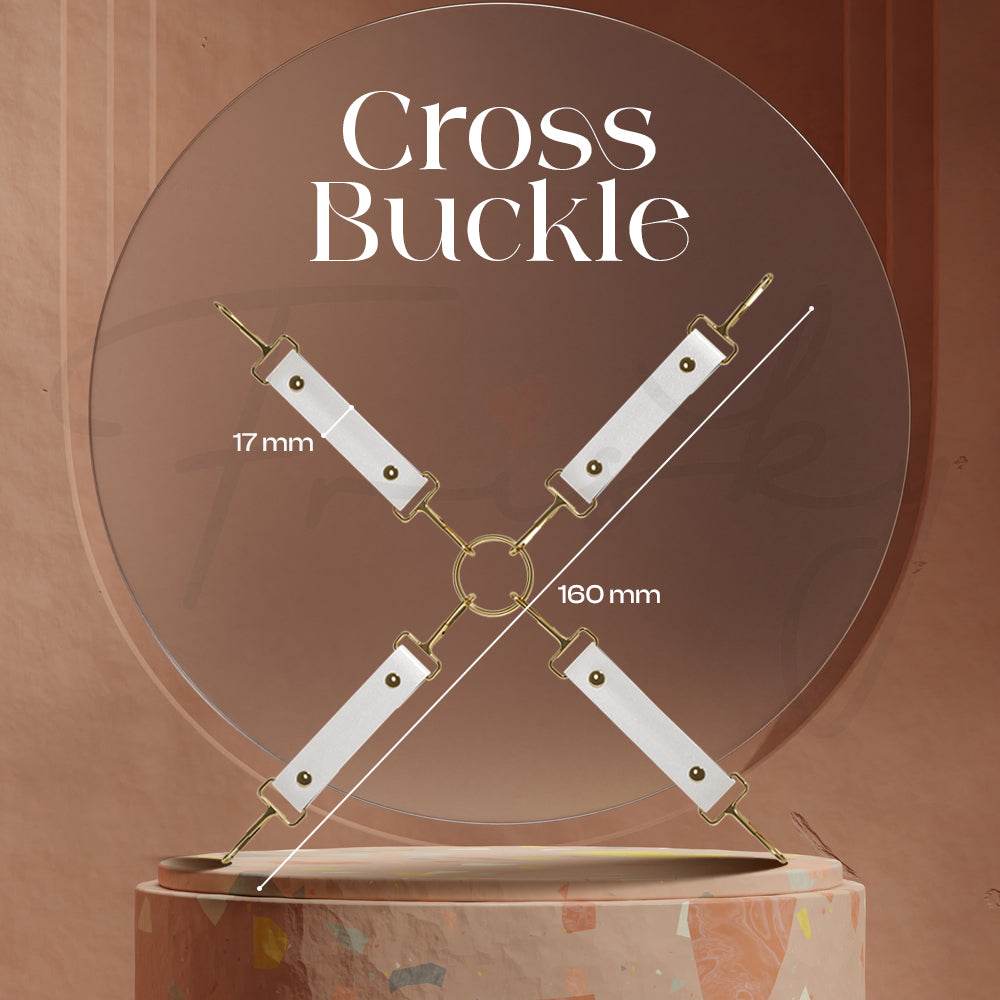 White cross-shaped restraint buckle shown mounted on a circular wooden backdrop.
