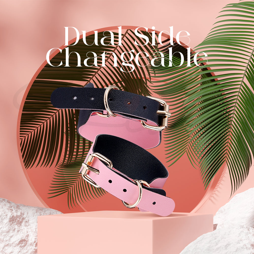 Set of pink and black accessories arranged neatly with plant accents in a styled scene.