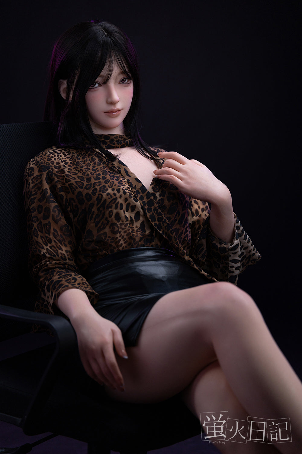 Full-body view of Firefly Diary Doll 161 cm Silicone – Linglong seated on a chair, wearing a leopard-print top and black skirt, highlighting her lifelike skin tone and natural sitting pose.