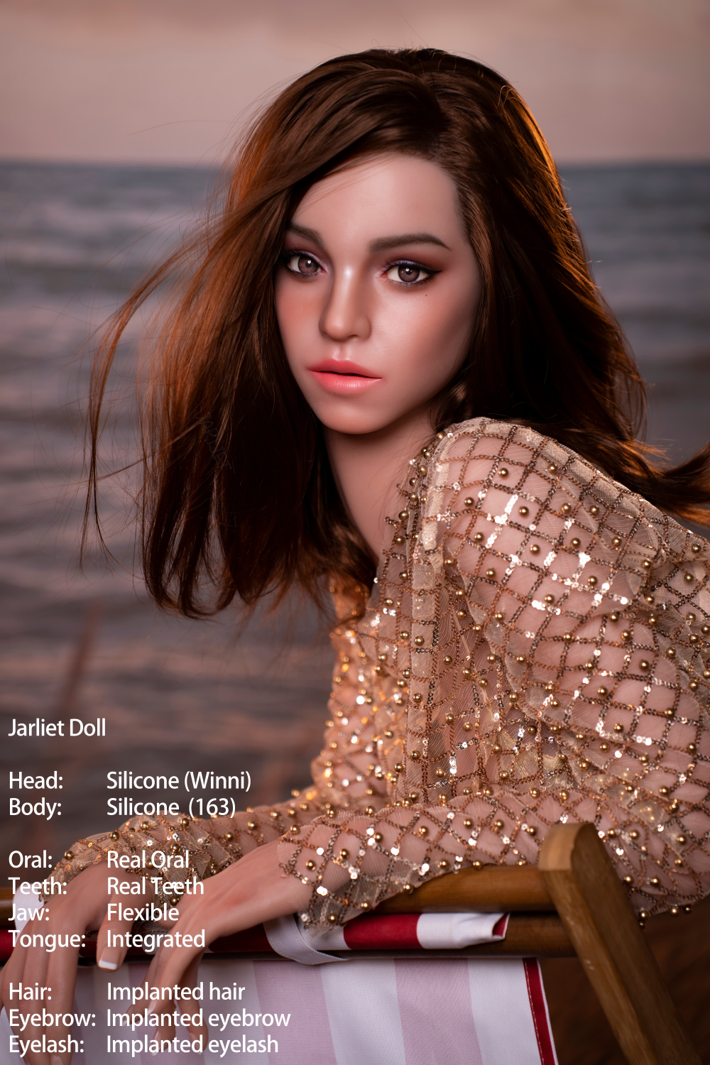A close-up portrait of the Jarliet Doll 163 cm D Silicone - Winni leaning against a beach chair. The image highlights her realistic facial features, including implanted hair, eyebrows, and eyelashes, with a blurred ocean background at dusk.