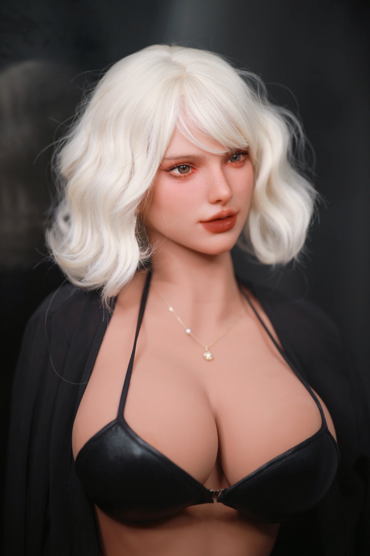 Fire Doll 166 cm E TPE - Rossi close-up upper body shot in black bikini top, short white wavy hair, dark dramatic background