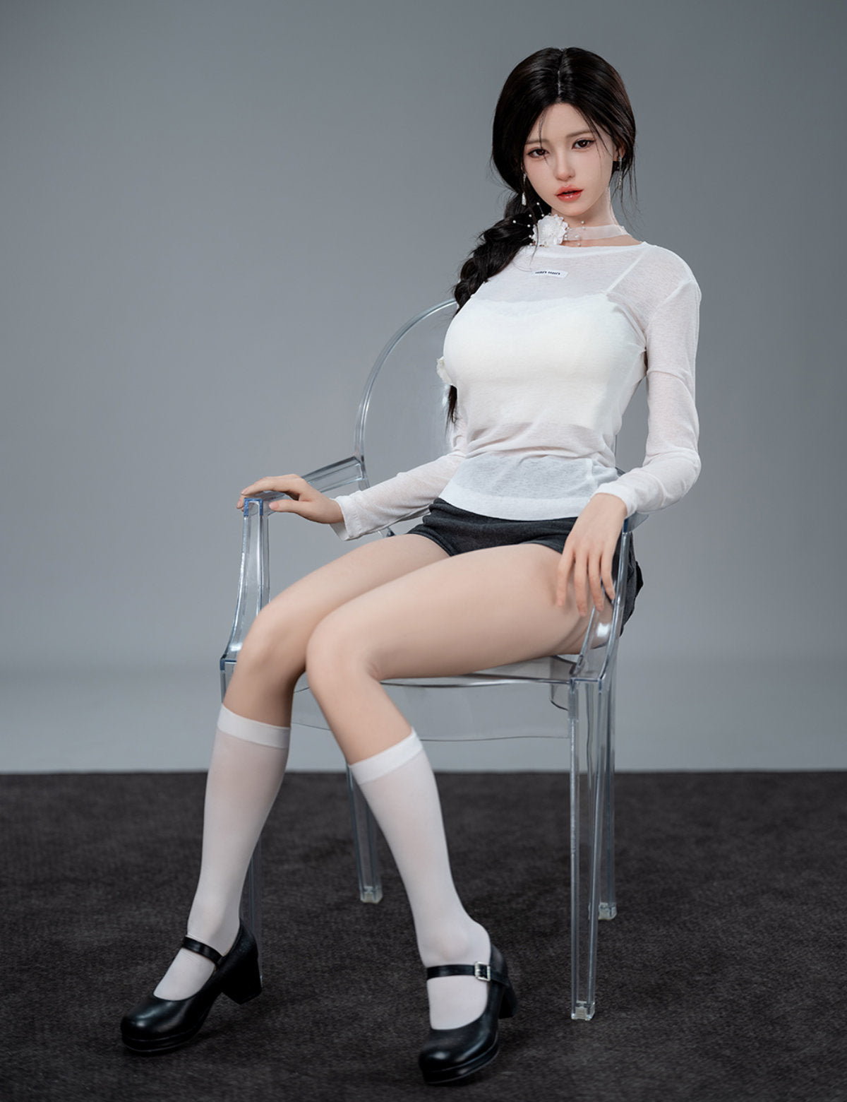 TOP-CYDOLL 168cm F-Cup Liang Realistic Sex Doll full body seated pose in white top and dark shorts on white surface, three-quarter front view