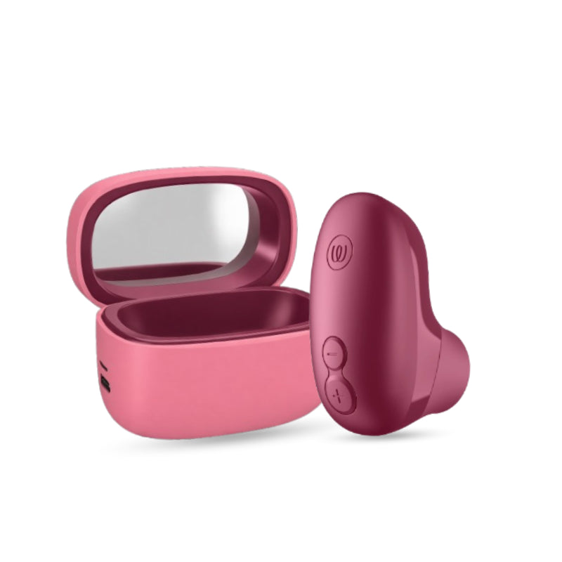 Womanizer Snap clitoral stimulator in crushed berry with pink charging case, displayed on a white background.