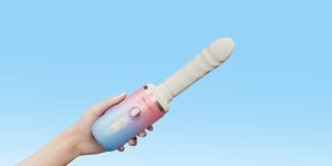 Lovense Spinel handheld device with ergonomic design against colored background Singapore