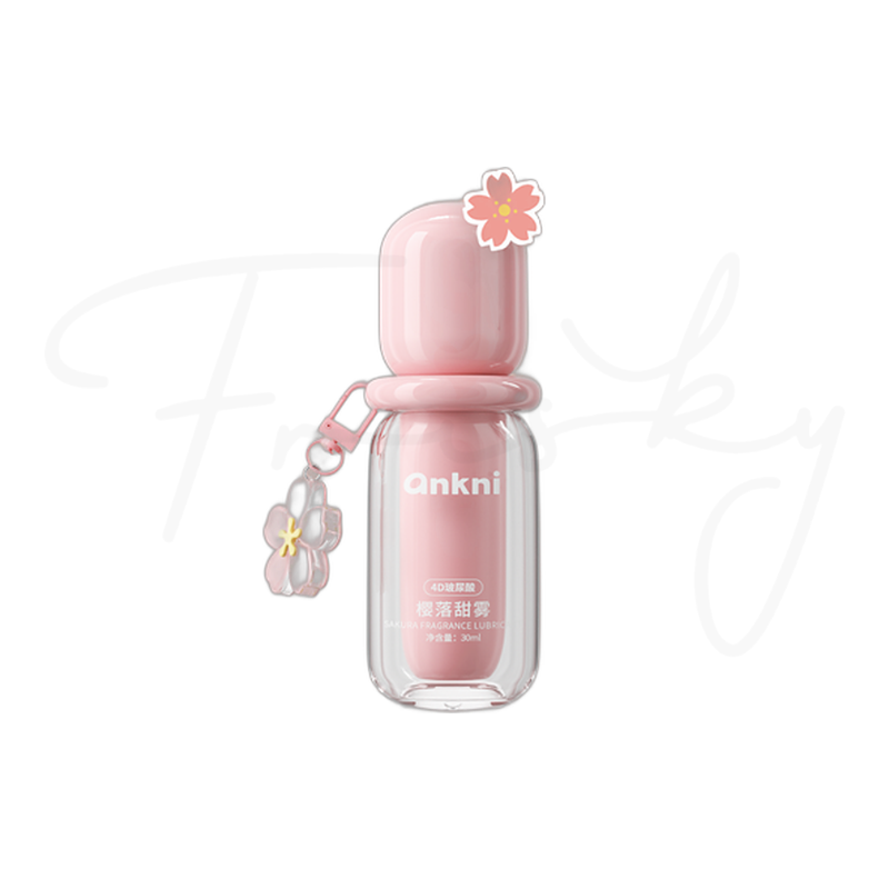 Pink lubricant bottle with a flower charm on a plain white background