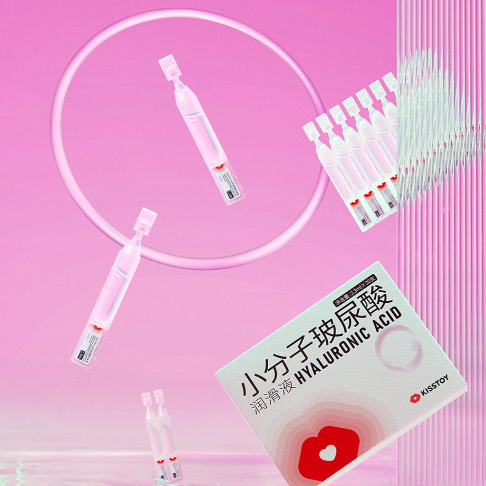 Lubricant vials lined up beside a Kisstoy companion kit box on a pink background