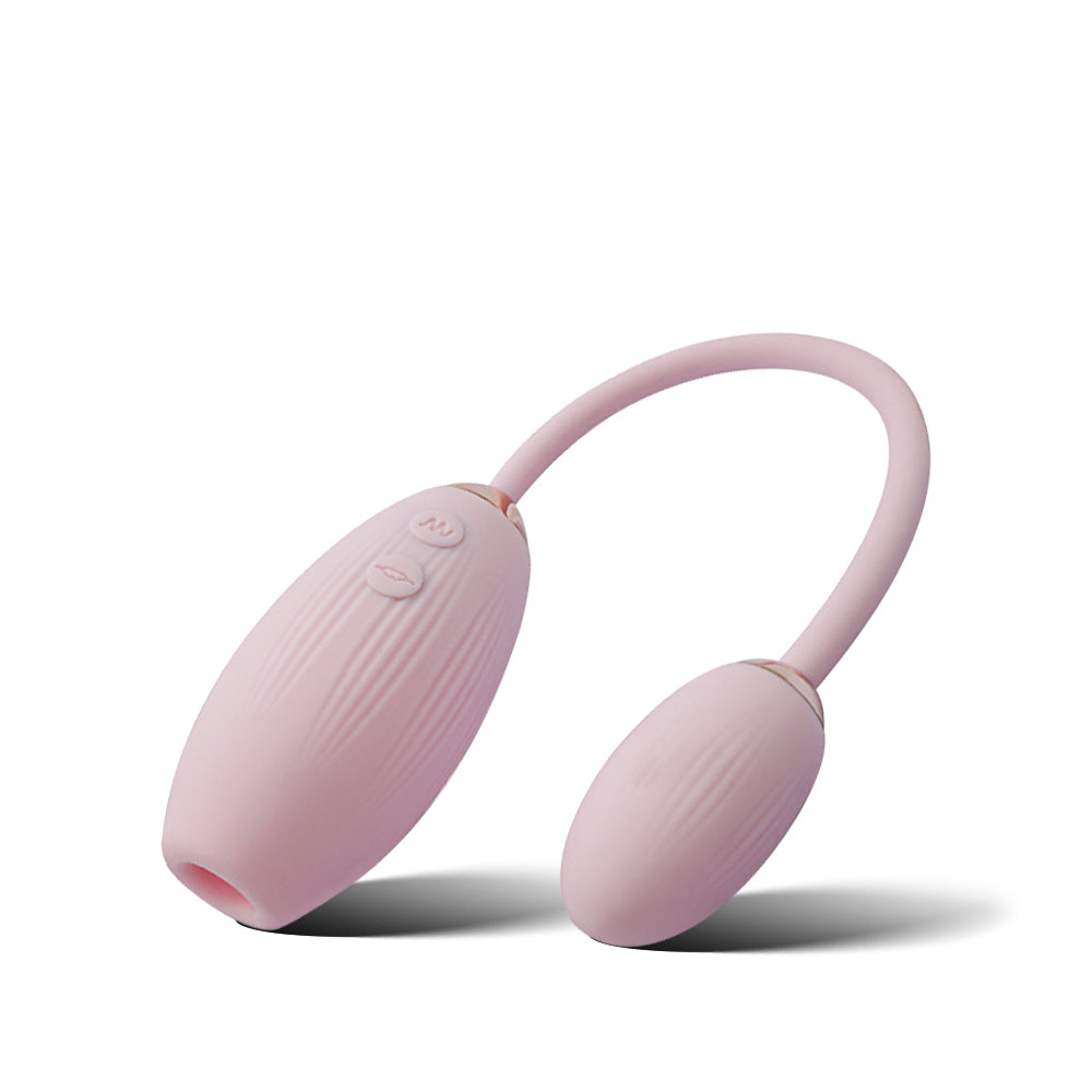 Sweet Lola dual-egg vibrator with connecting cord shown in soft pink silicone finish