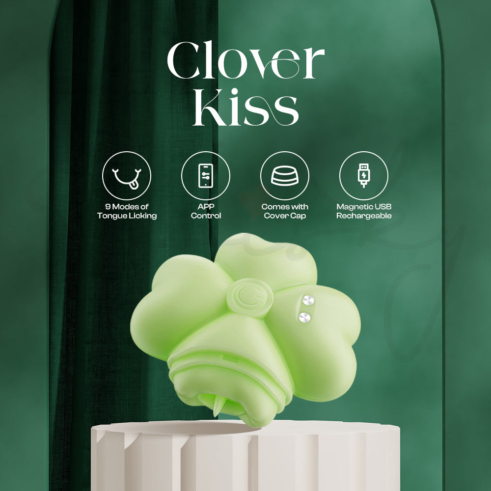 Clover-shaped green stimulator displayed beside its cover cap on a clean surface.