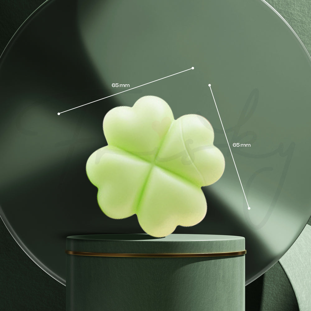 Green clover stimulator placed upright on a transparent magnetic charging stand