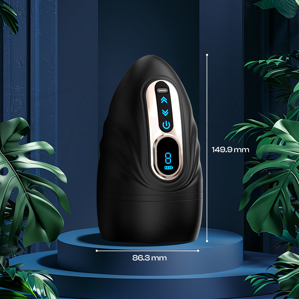 Black vibrator standing on a minimal blue platform with soft lighting and decorative greenery.