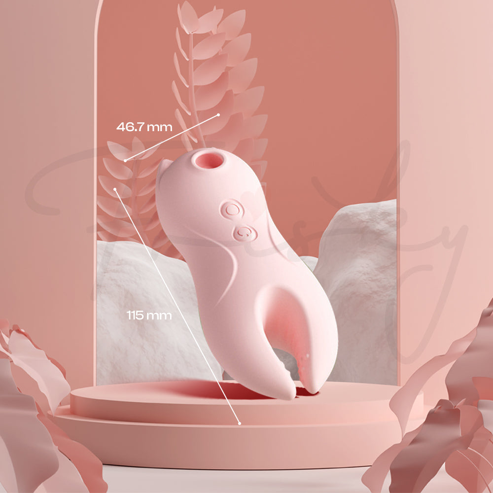 Pink vibrator standing on a decorative dish with soft draped fabric and warm, aesthetic lighting.