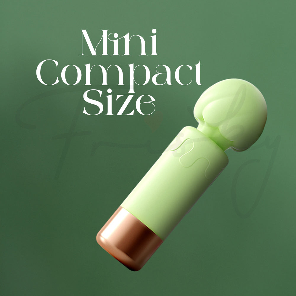 Small mint-green vibrator laying on its side showcasing its compact, travel-friendly size