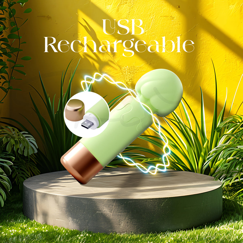 Green mini vibrator on a stone base in a garden setting emphasizing USB rechargeability.