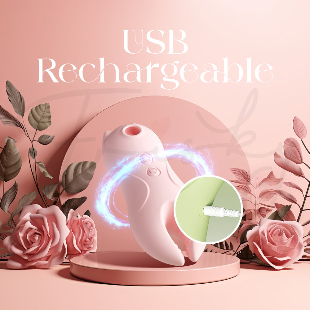 Close-up of the pink vibrator being connected to a USB charging cable on a soft pink background.