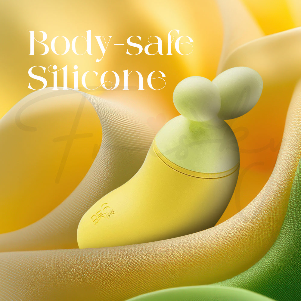 BanaRush vibrator resting on yellow fabric, highlighting its smooth, body-safe silicone material.