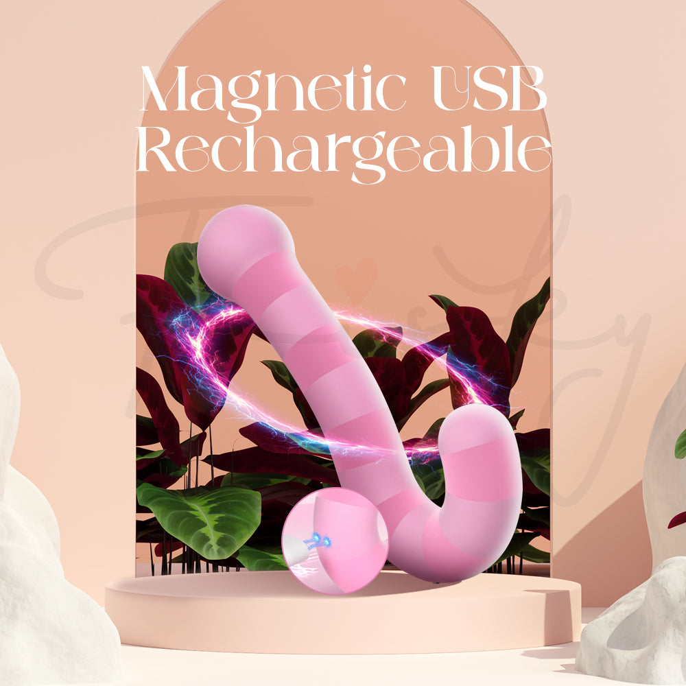 Magnetic USB charging cable attached to the pink dual vibrator on a pastel background