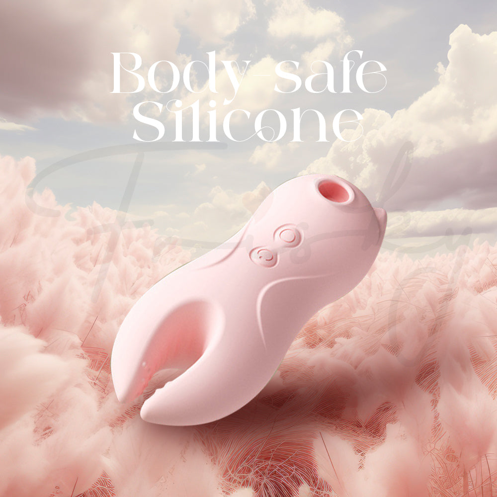 Pink clitoral vibrator resting on plush fabric to highlight its smooth, body-safe silicone material.