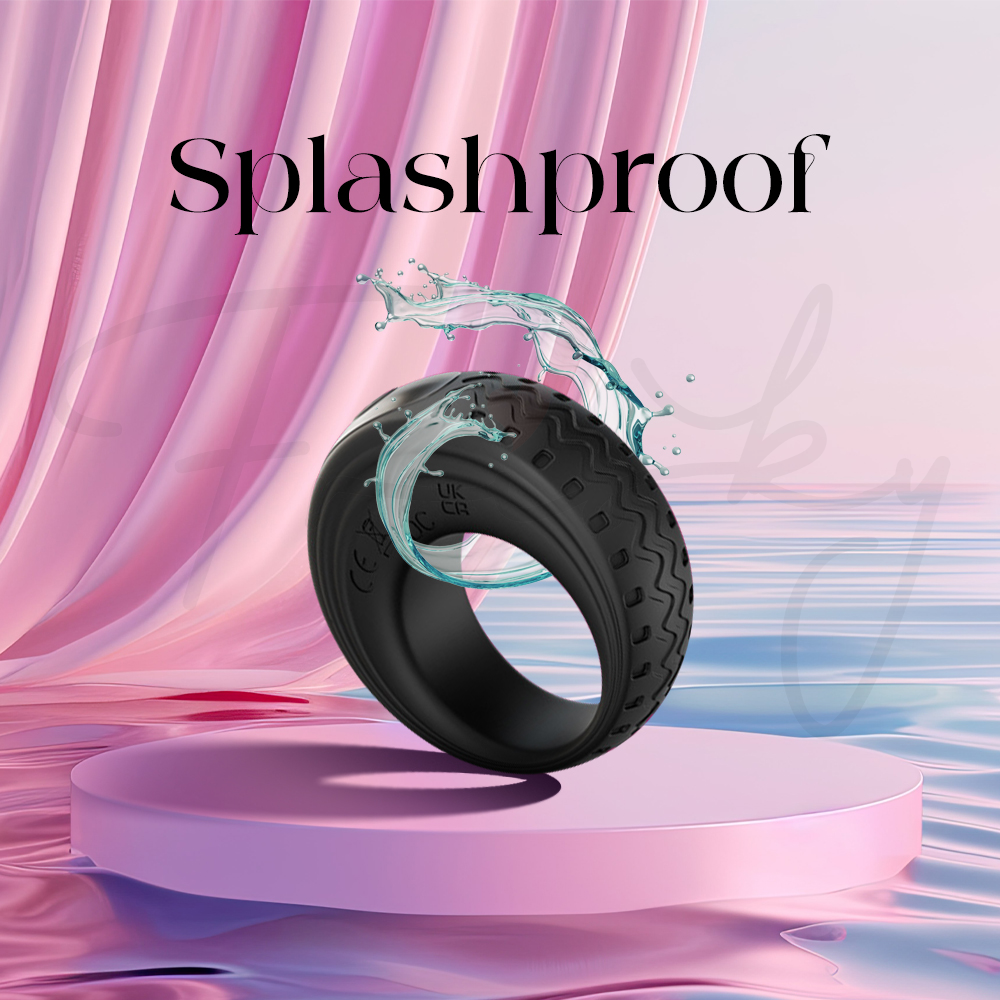 Black vibrating ring splashed with water to demonstrate splashproof design
