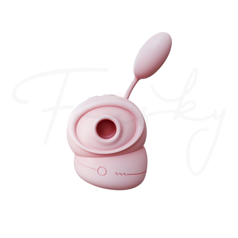 Pale pink suction stimulator and egg with cord on a plain white background