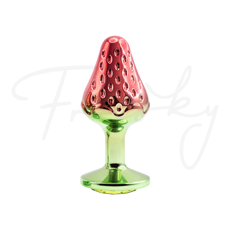 Strawberry-shaped 130g metal plug displayed upright with polished green decorative base