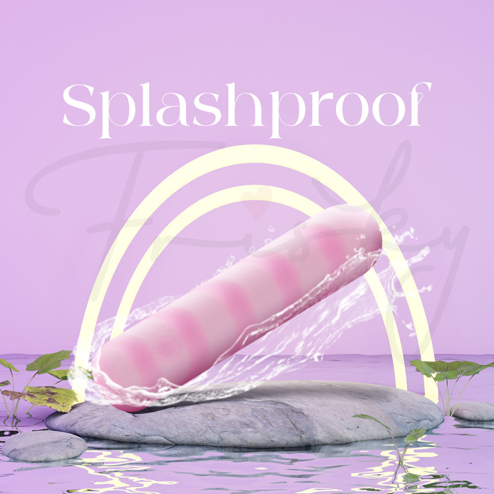 Pink striped vibrator on wet stones with water droplets showing its splashproof design.