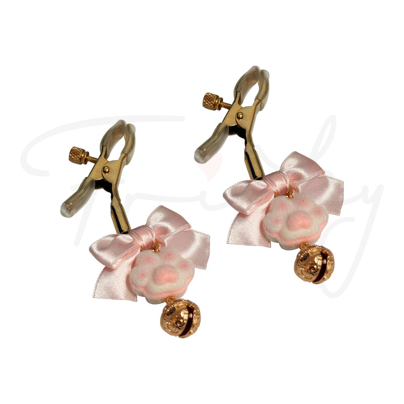 Pair of gold nipple clamps with pink ribbons on a white background