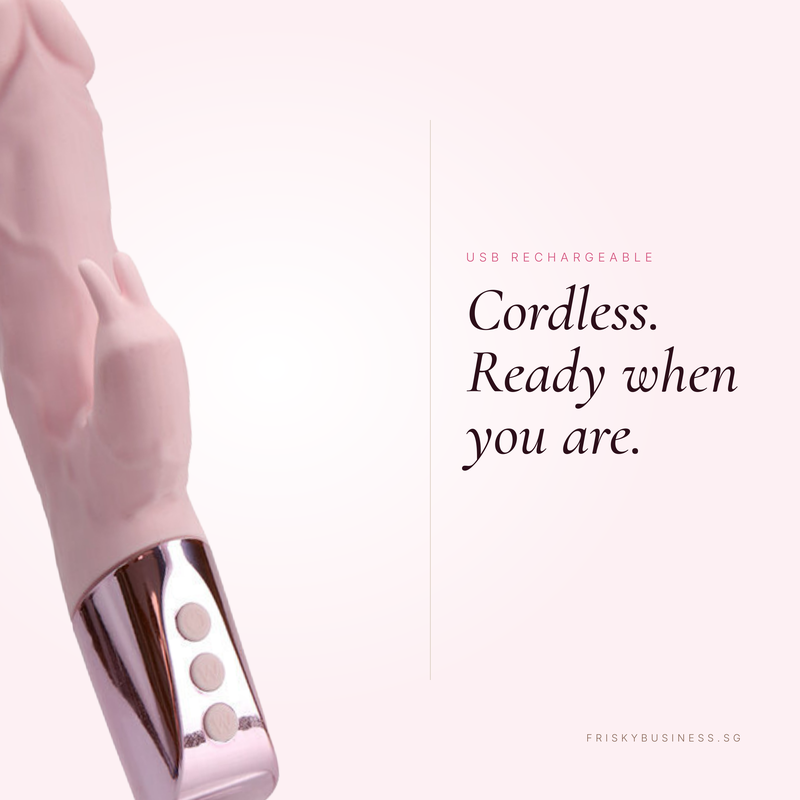 A close-up of a pink and rose gold cordless personal rabbit vibrator sex toy with three control buttons, shown next to promotional text on a pale pink background.