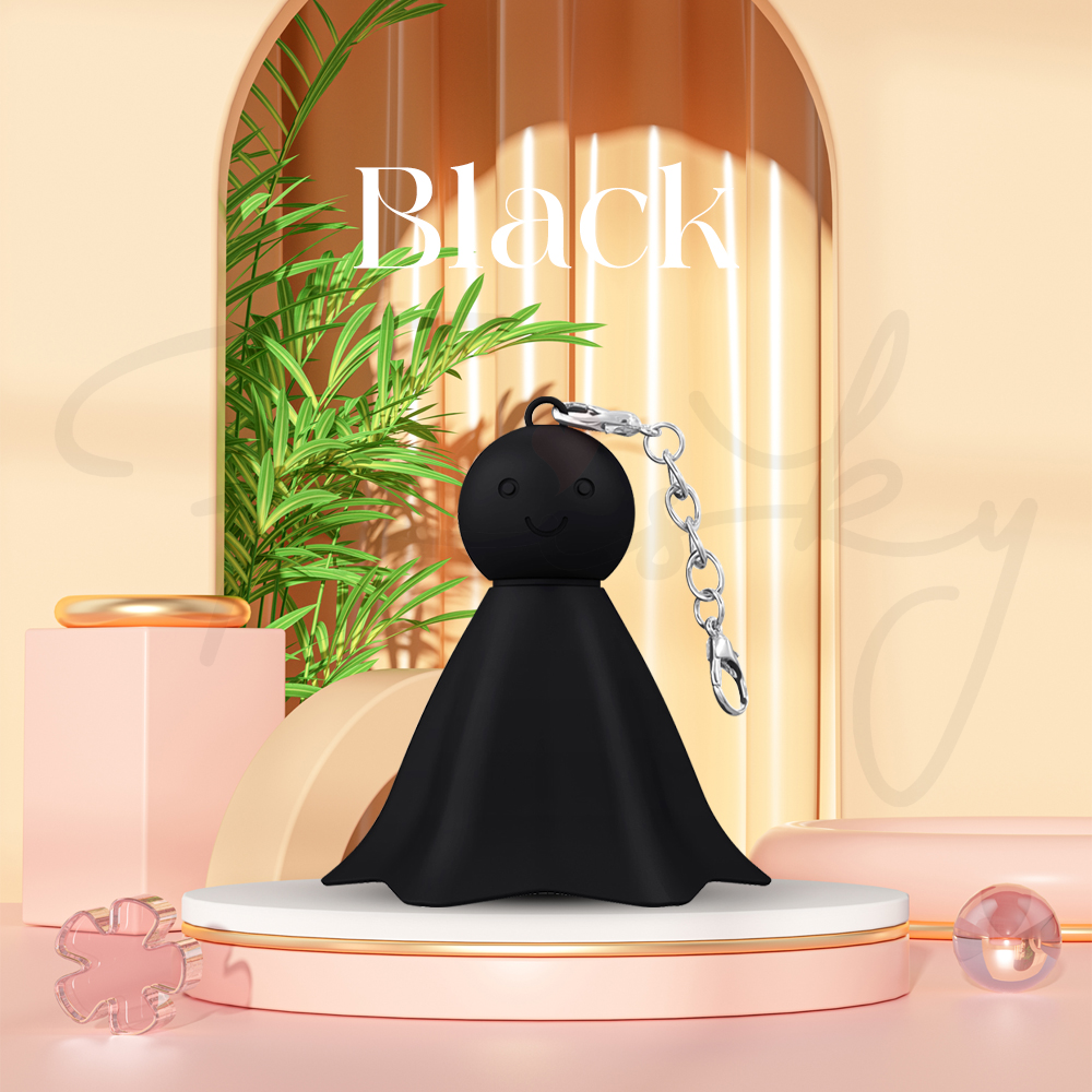 Black Echo Ring vibrating keychain displayed in natural plant setting