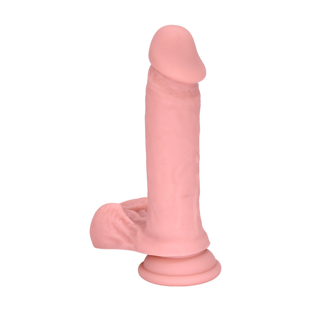 Side profile of realistic dildo highlighting smooth shaft, rounded head, and suction base