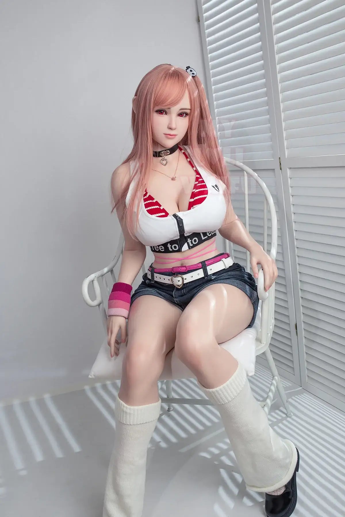 Jiusheng Doll 152 cm E Silicone – Honoka seated on a chair, wearing a casual sporty outfit with pink hair and lifelike skin texture.