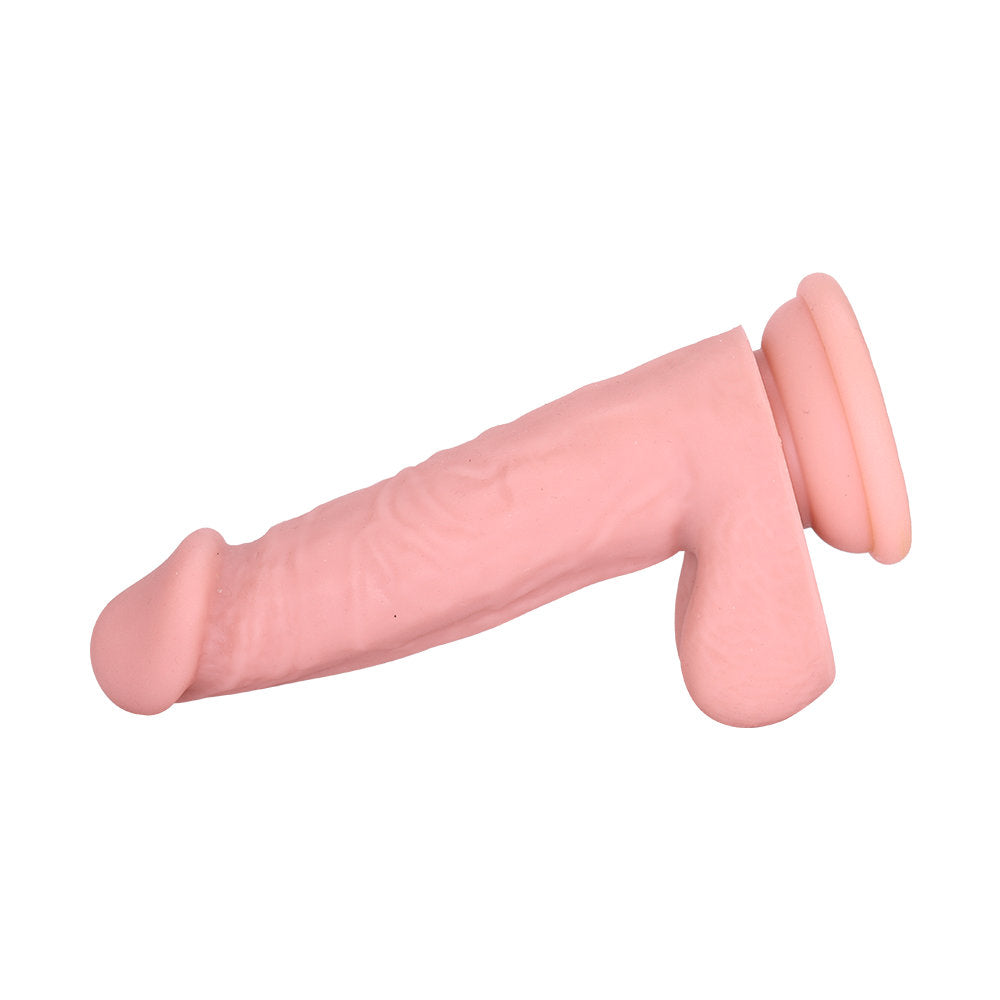 Realistic dildo shown laid flat highlighting flexibility, curved shaft, and firm suction cup base.