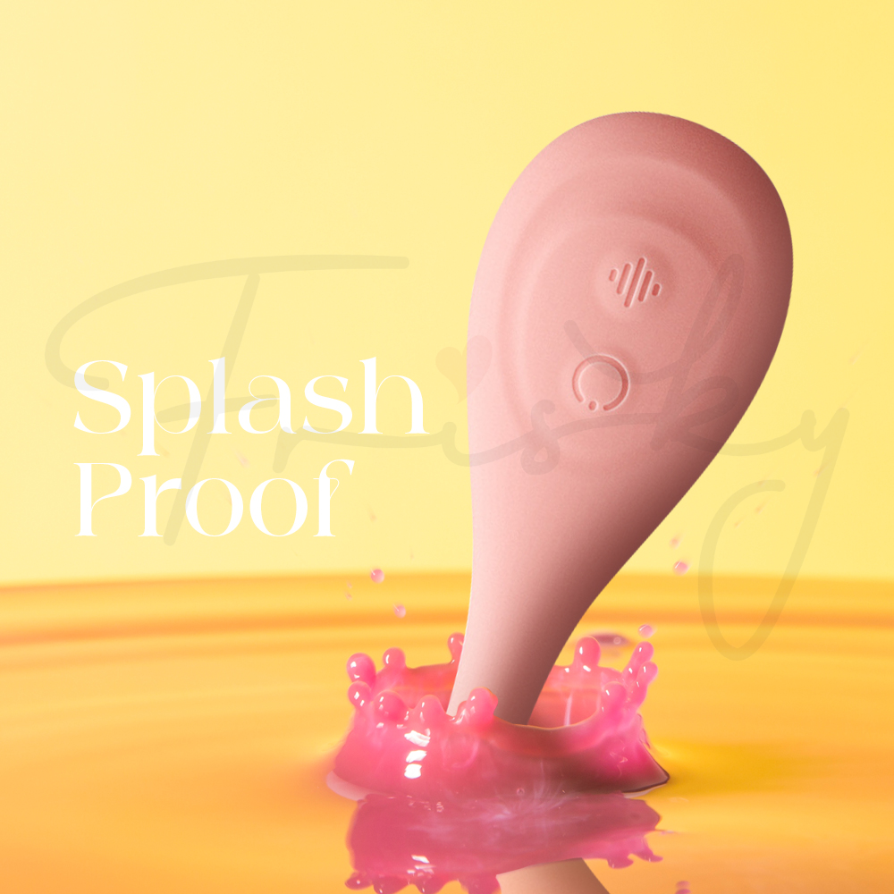 Splashproof vibrator partially surrounded by water droplets on bright background