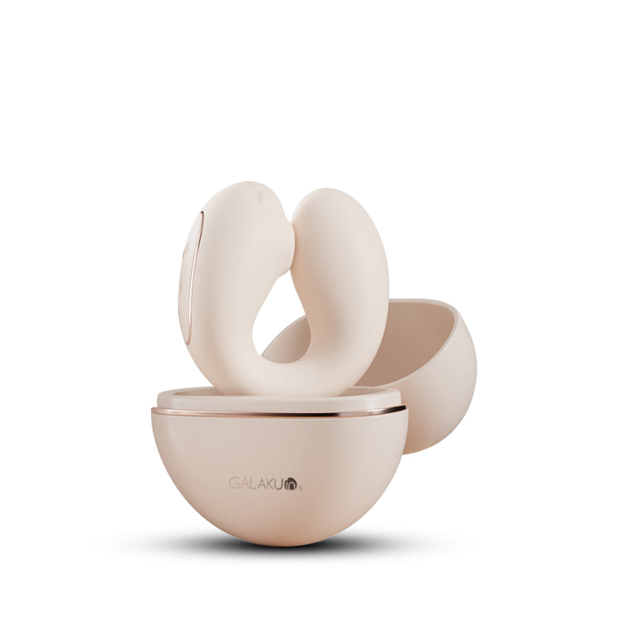 Beige wearable suction vibrator in charging case with curved ergonomic dual-loop design