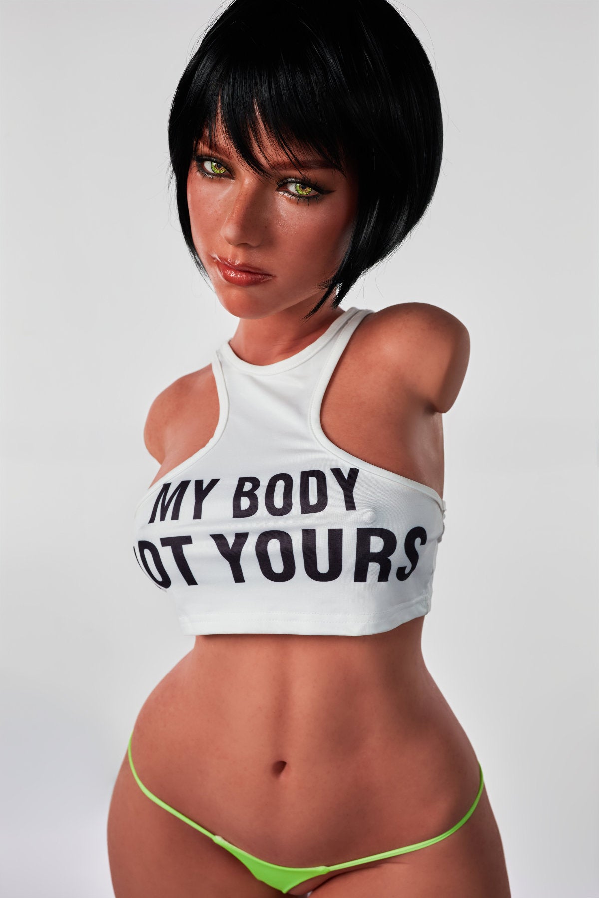 A front view of the CLIMAX DOLL - ULW 882# Silicone Torso - Livia (Black), featuring a doll with short black hair wearing a white crop top that says "MY BODY NOT YOURS" paired with neon green bikini bottoms.