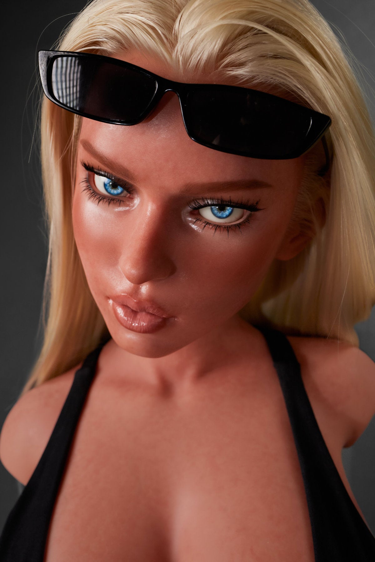 A close-up headshot of the blonde CLIMAX DOLL - ULW 883# Silicone Torso - Fiora (Black) with sunglasses resting on her forehead.