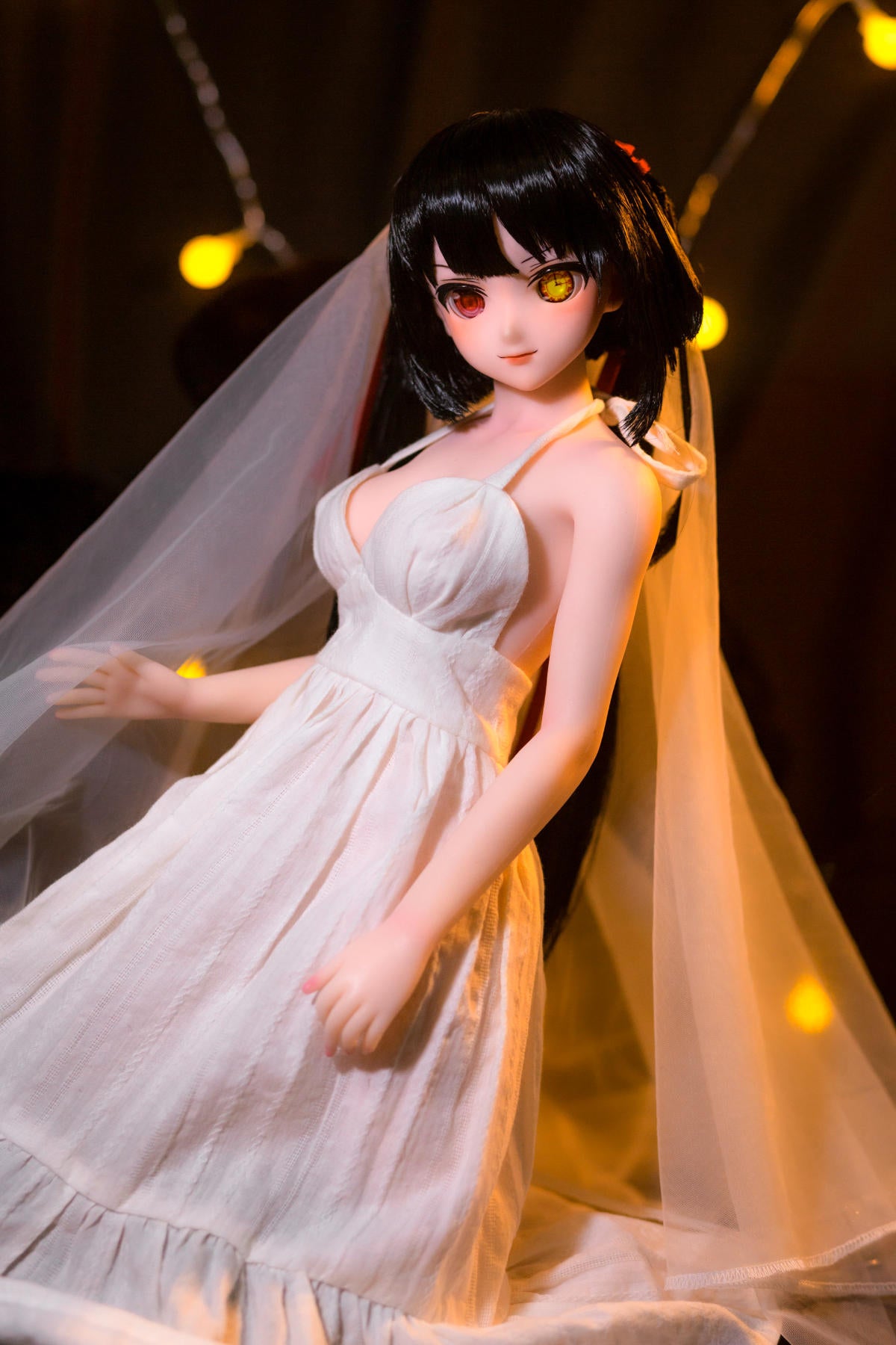 CLIMAX DOLL Mini J60 cm Hybrid - Kurumi (Cinnamon) - Angled, leaning pose with head tilted and veil draped over her hair, fitted white bodice, fairy-light bokeh.