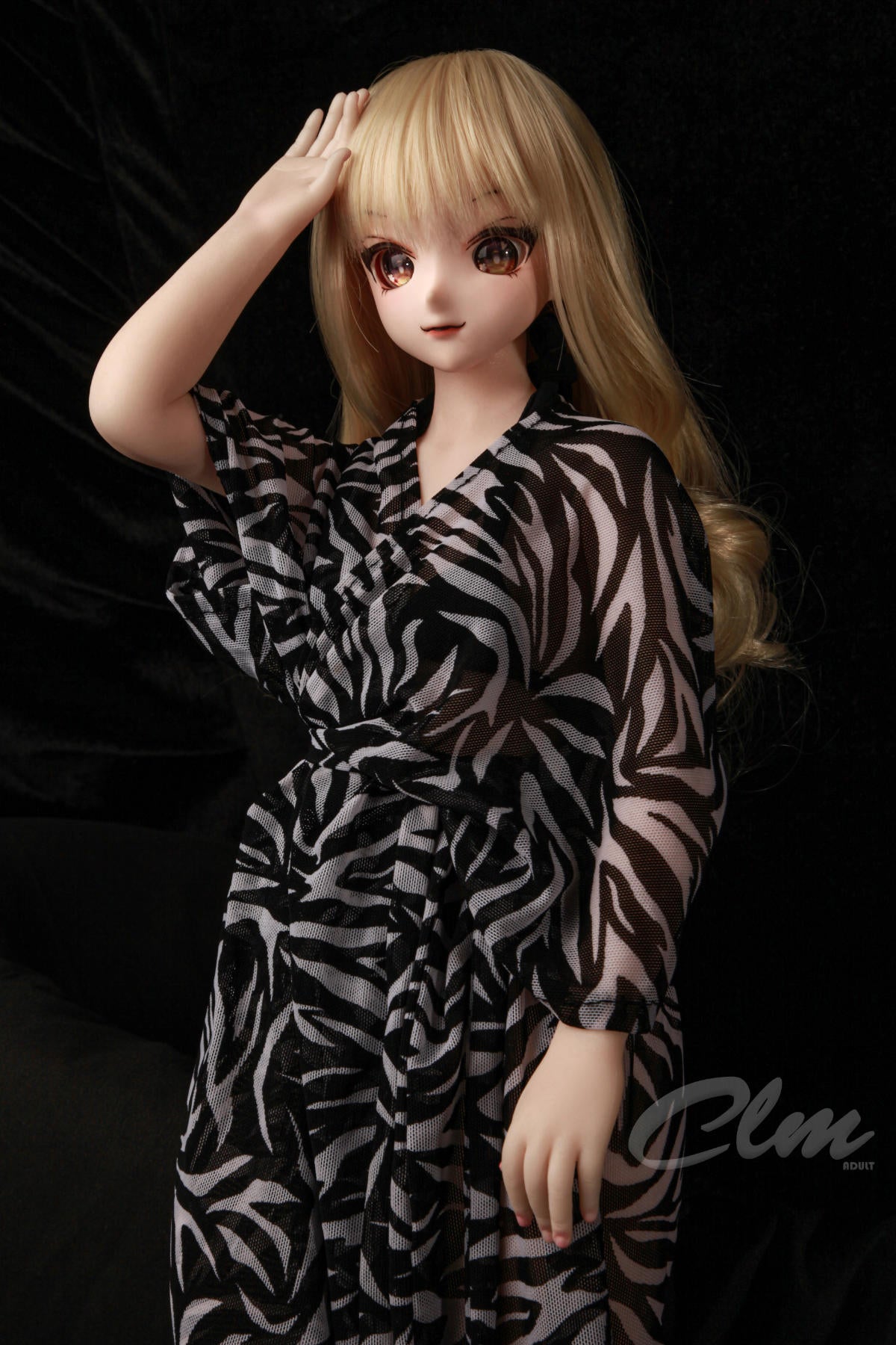 CLIMAX DOLL Mini J60cm XS Hybrid - Nagisa (Cinnamon) standing pose with one hand raised to her head, zebra-print robe, black backdrop