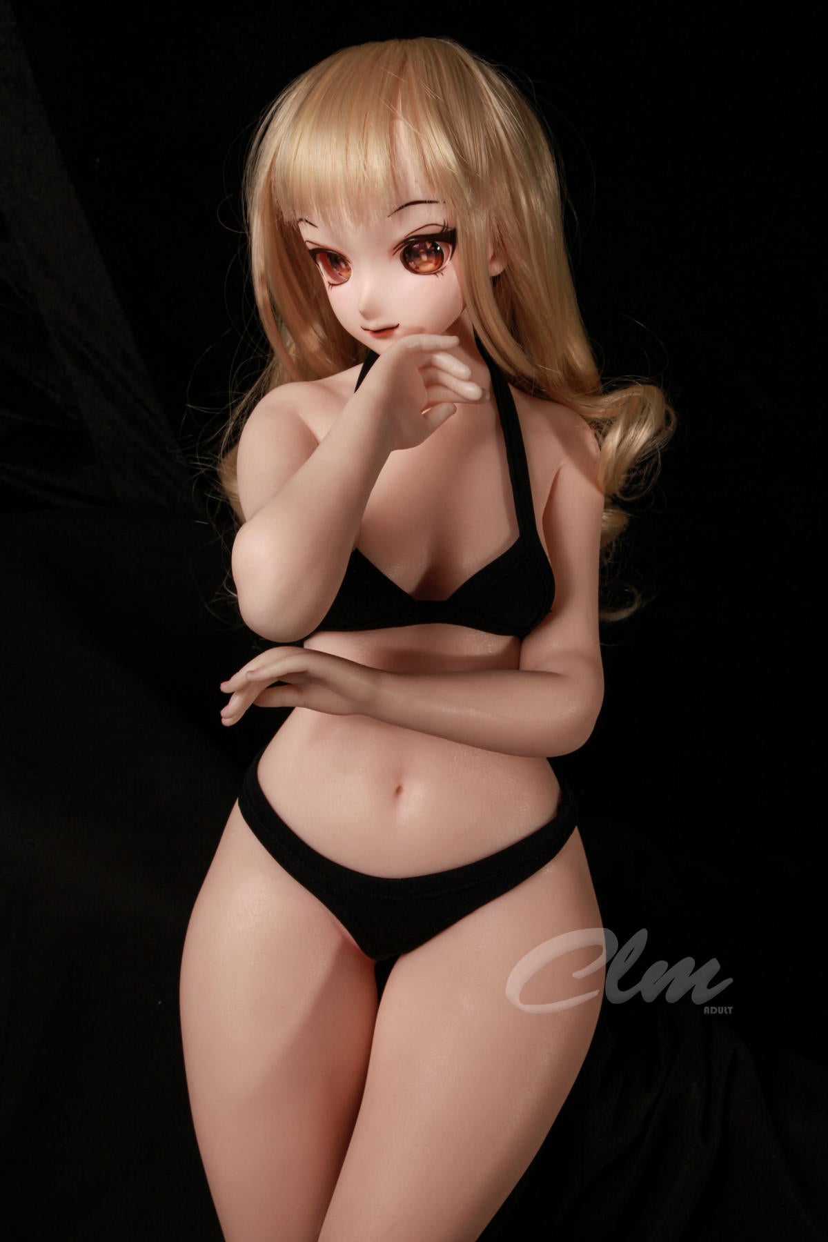CLIMAX DOLL Mini J60cm XS Hybrid - Nagisa (Cinnamon) standing pose in a black bikini set with arms crossed over her chest, black backdrop