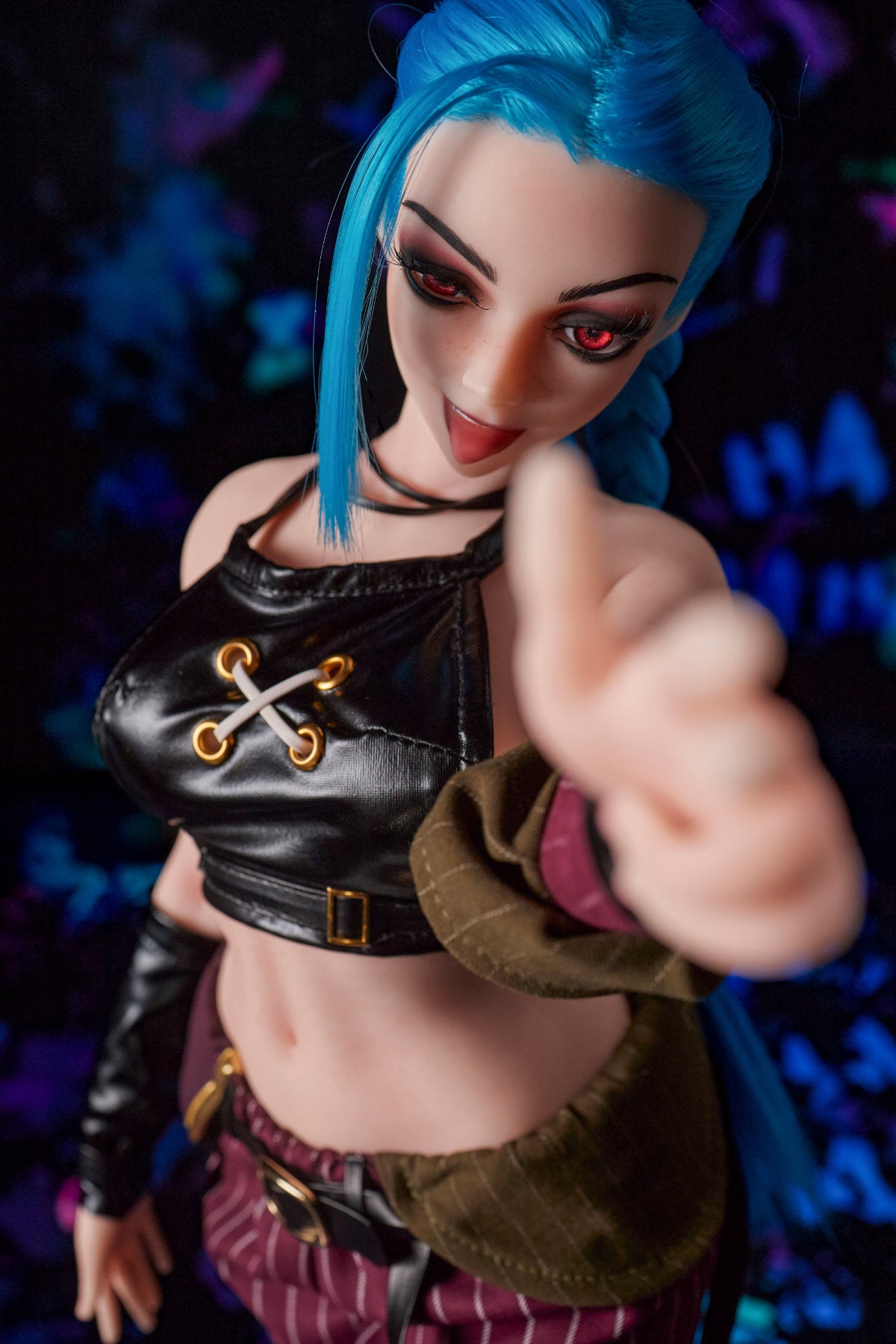 CLIMAX DOLL Mini Si70cm MO Silicone - Jetta (Cinnamon) upper body front view in black crop top with finger point pose, blue hair, dark bokeh background
