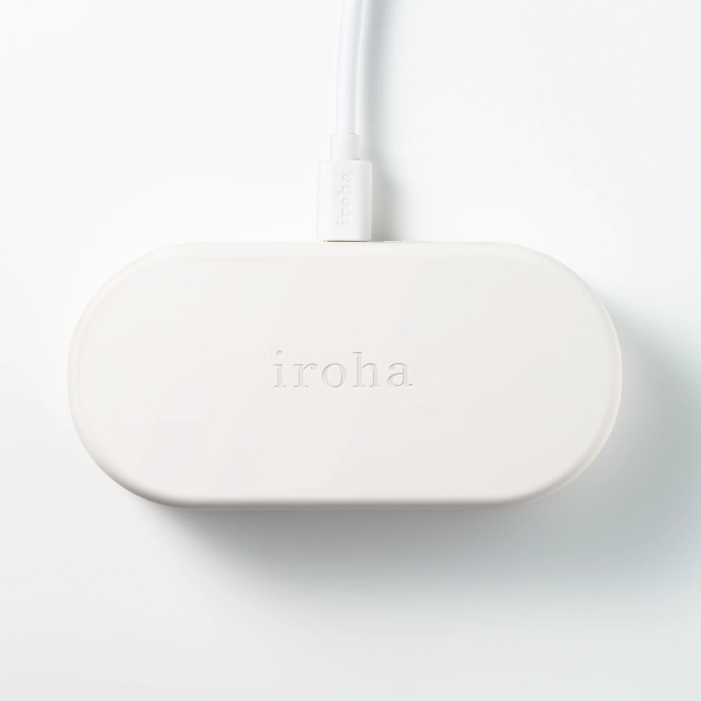 Minimalist white charging case with Iroha branding designed for discreet storage and charging