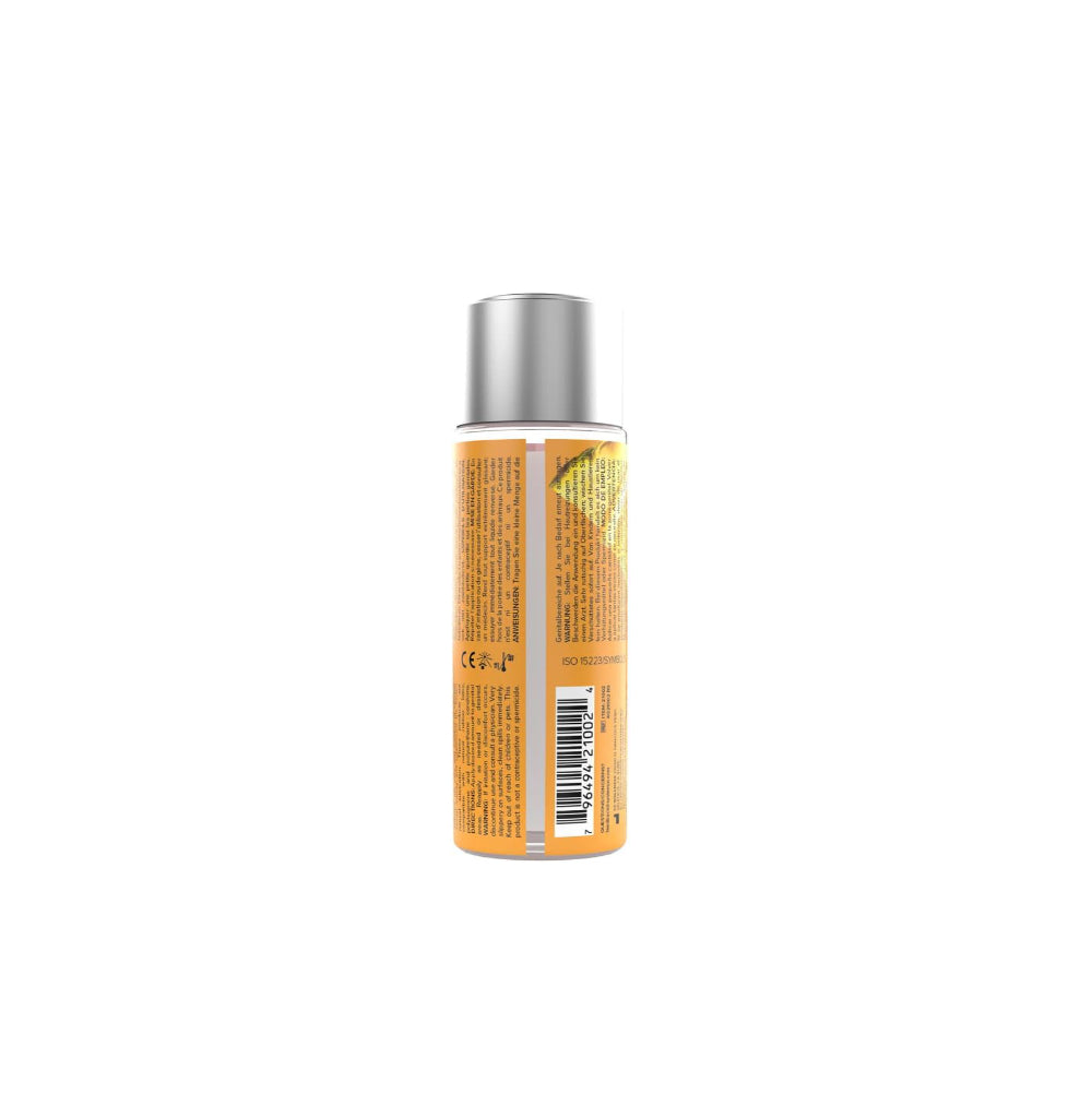 Lubricant bottle with orange label and silver cap on a white background
