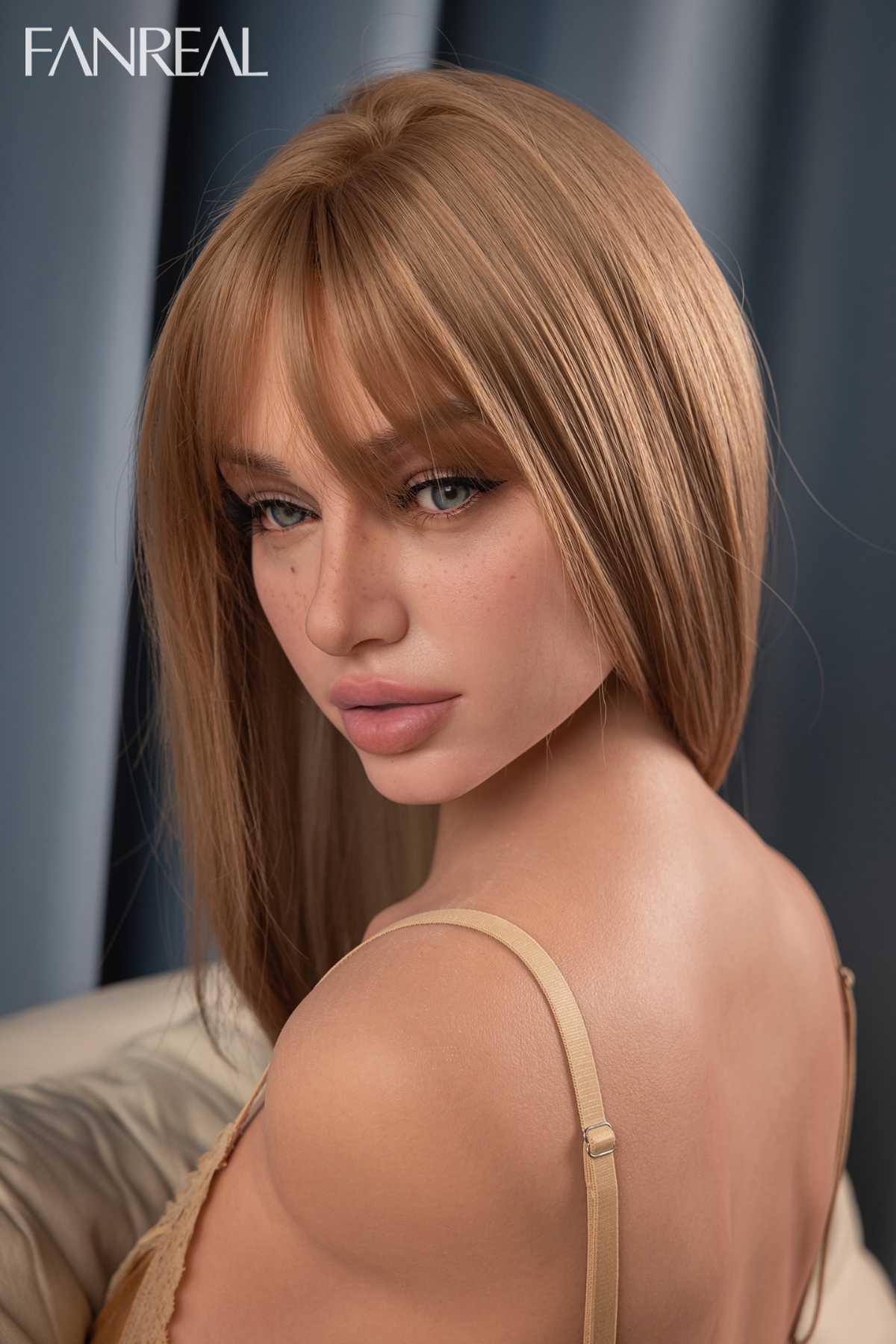 FANREAL DOLL T111 CM F Silicone Torso - Lila V4 close-up face pose, with wavy strawberry-blonde hair, in an indoor gray curtain background.
