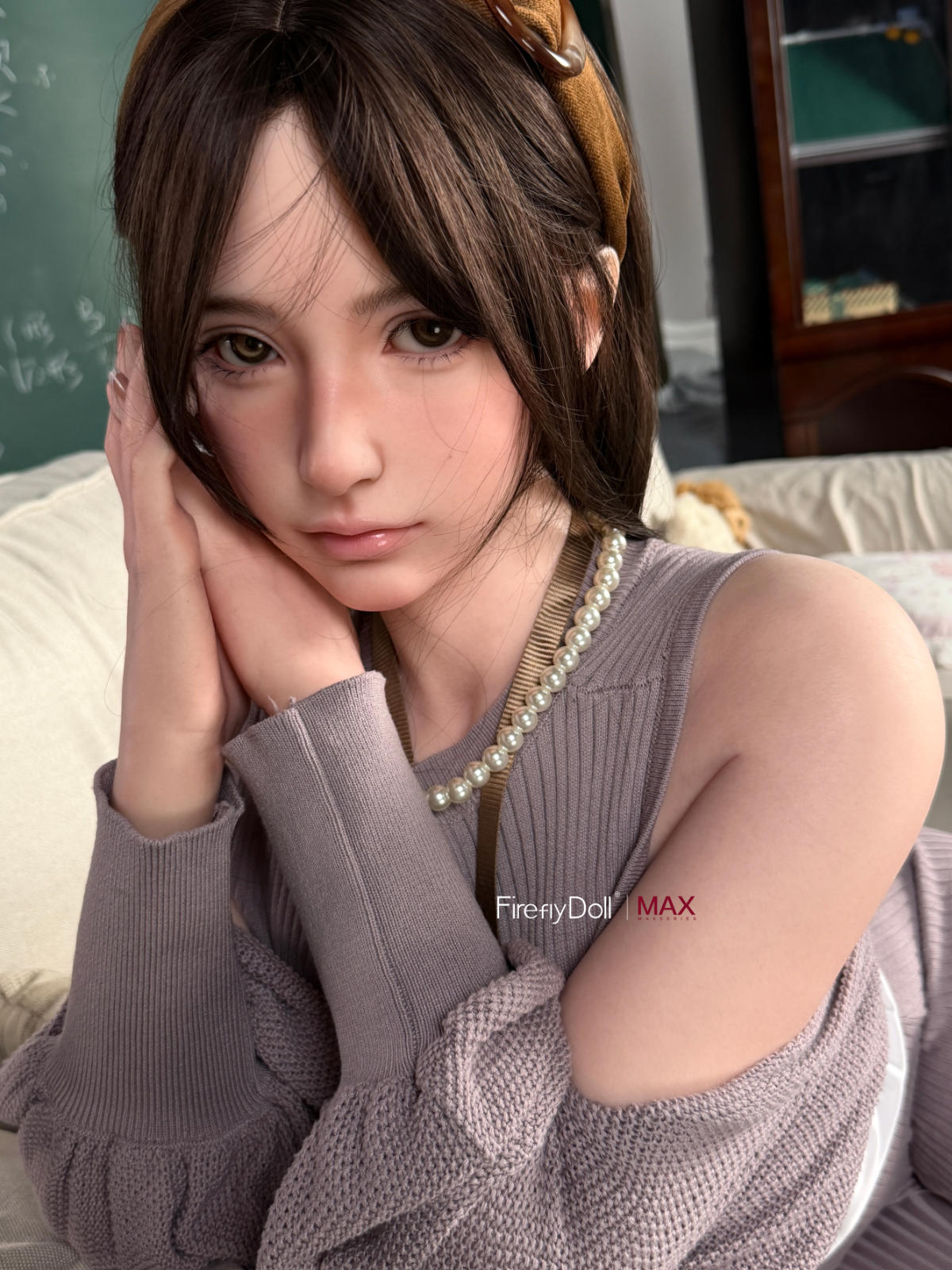 Firefly Diary Doll 165 cm B Max Series Silicone - Haruko V2 seated portrait in a gray knit sweater dress, pearl necklace, dark auburn wavy bob, cozy interior backdrop