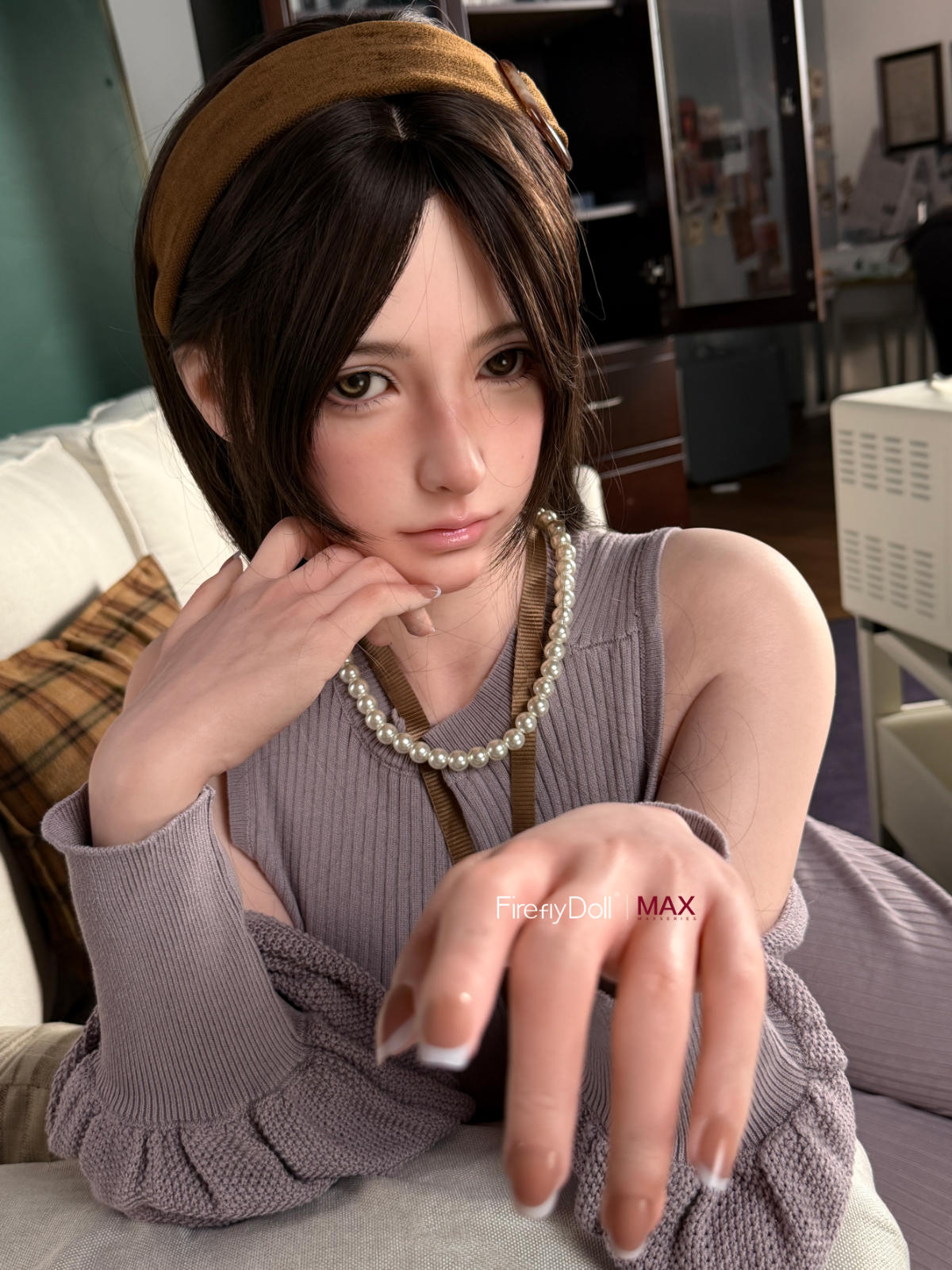 Firefly Diary Doll 165 cm B Max Series Silicone - Haruko V2 seated close-up in a gray knit sweater dress, cream couch backdrop