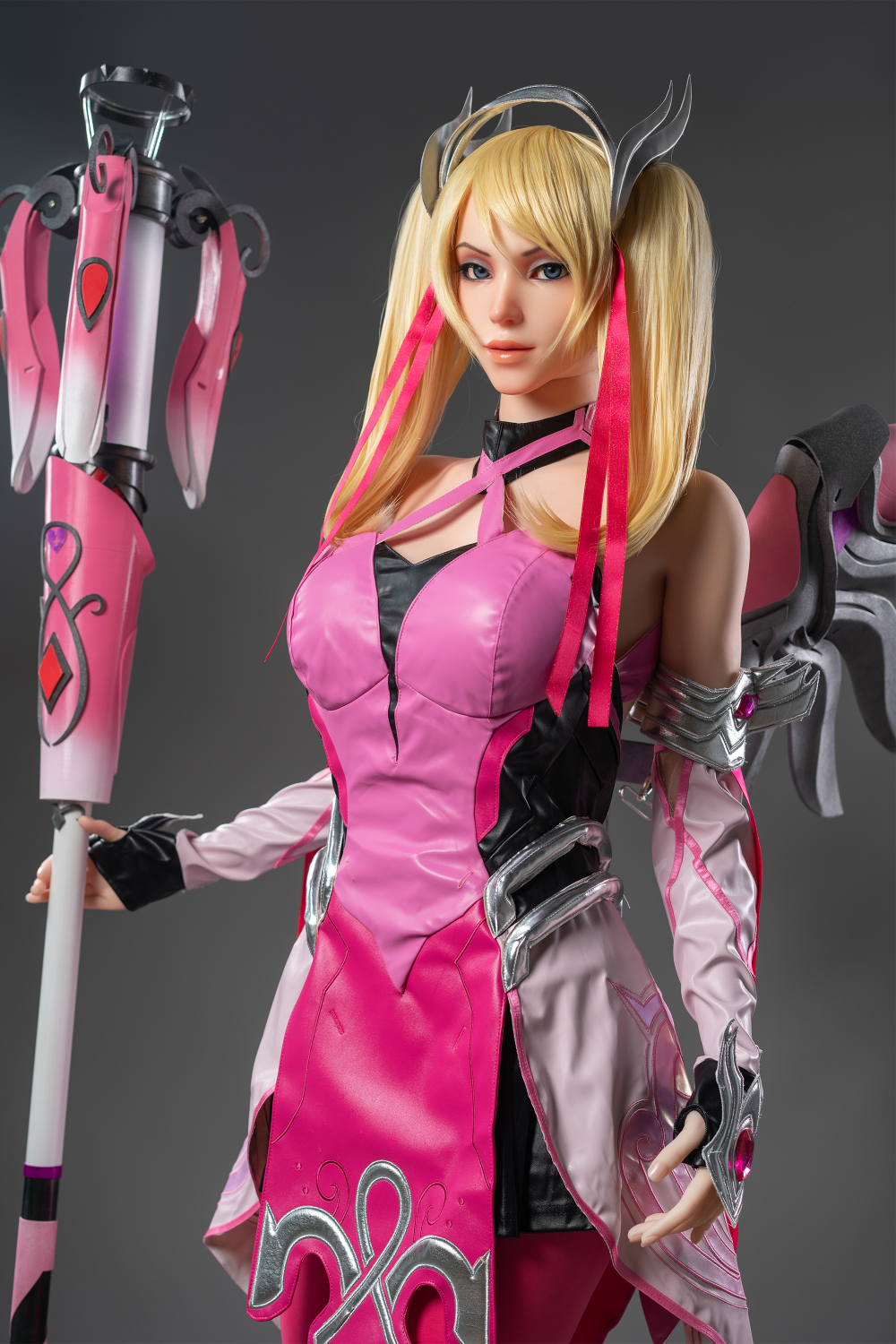 Game Lady 171 cm G Silicone - Mercy in a pink and black outfit with a weapon.